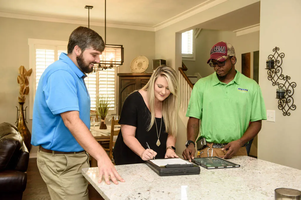 Technician maintaining an HVAC unit
